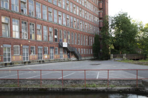 Image of East Mill, Belper showing boarded up windows.